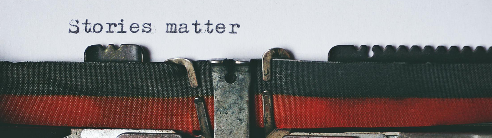 Ribbon on a typewriter with the words "stories matter" above