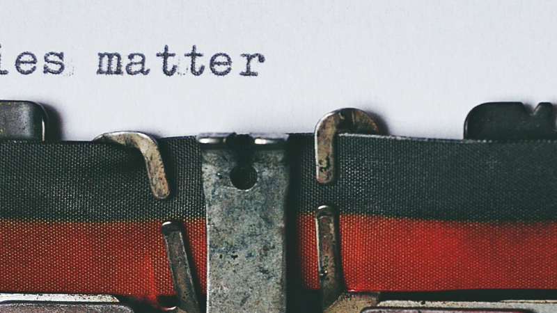 Ribbon on a typewriter with the words "stories matter" above