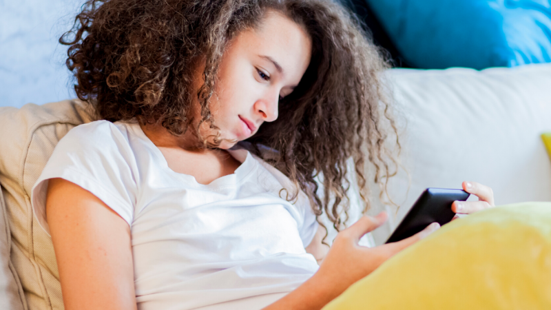 Teenage girl using new phone