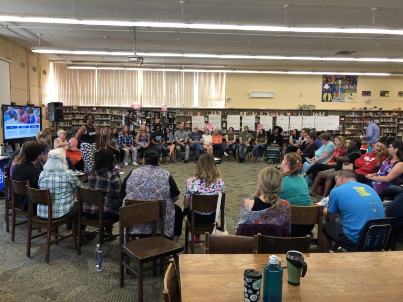 Erin Walsh as a guest speaker a middle school with educators in a circle.