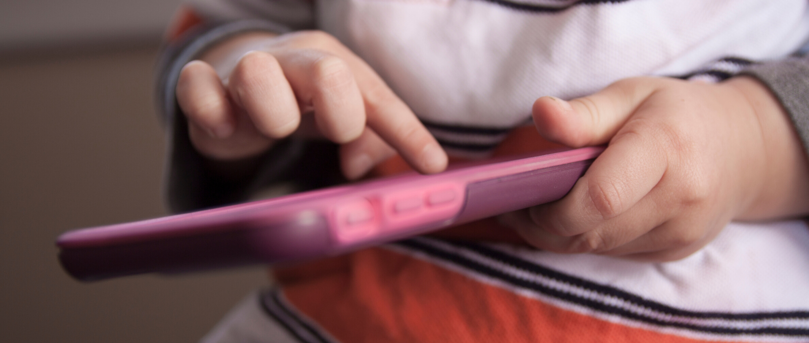 Young child scrolling through cell phone app