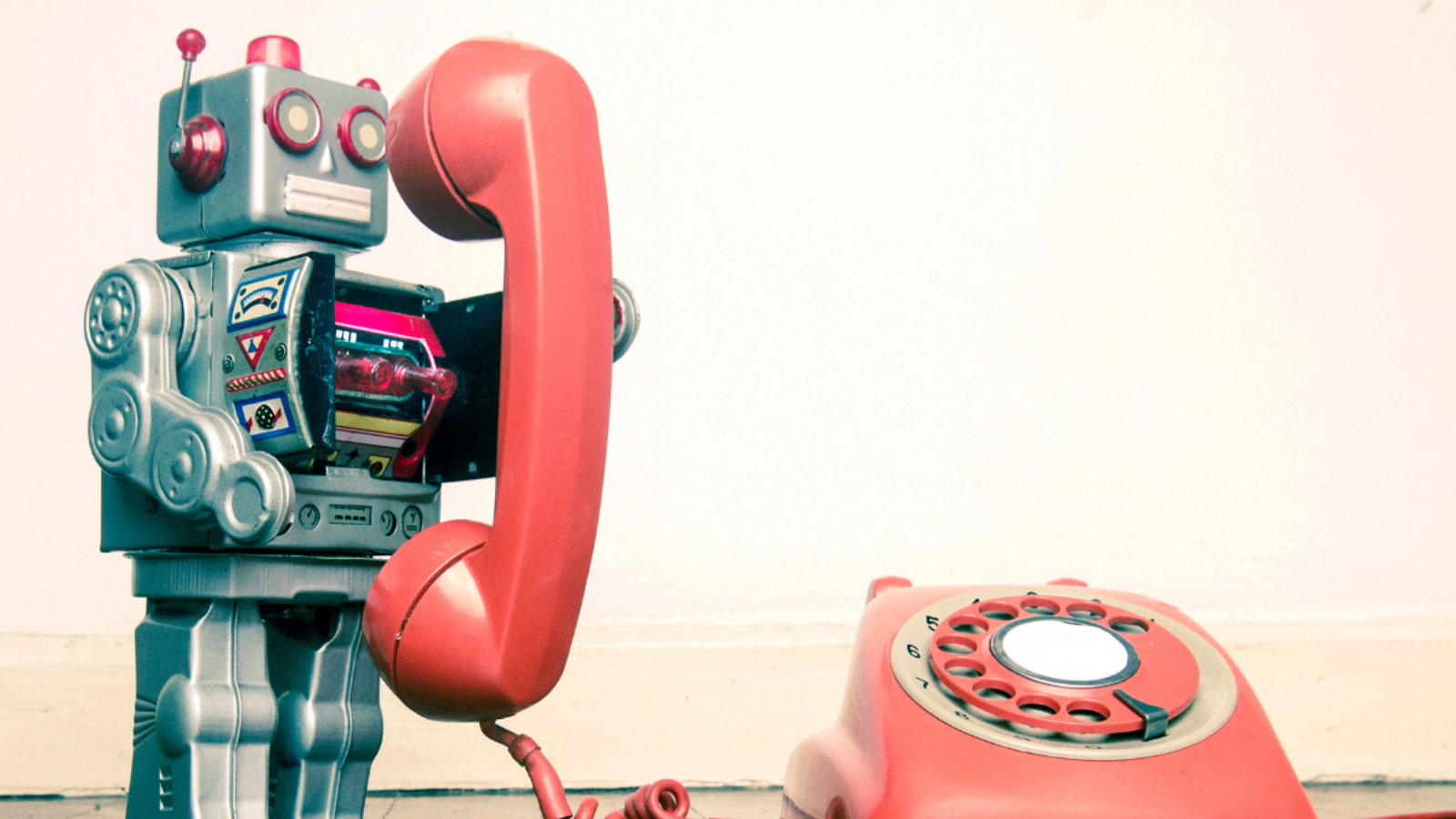 Talking toys including a robot talking on an old rotary phone