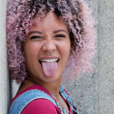 Teenager with pink hair and a nose ring.