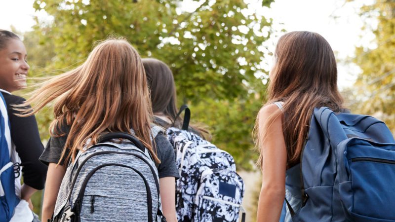 Teens walking to school and roaming the neighborhood independently.
