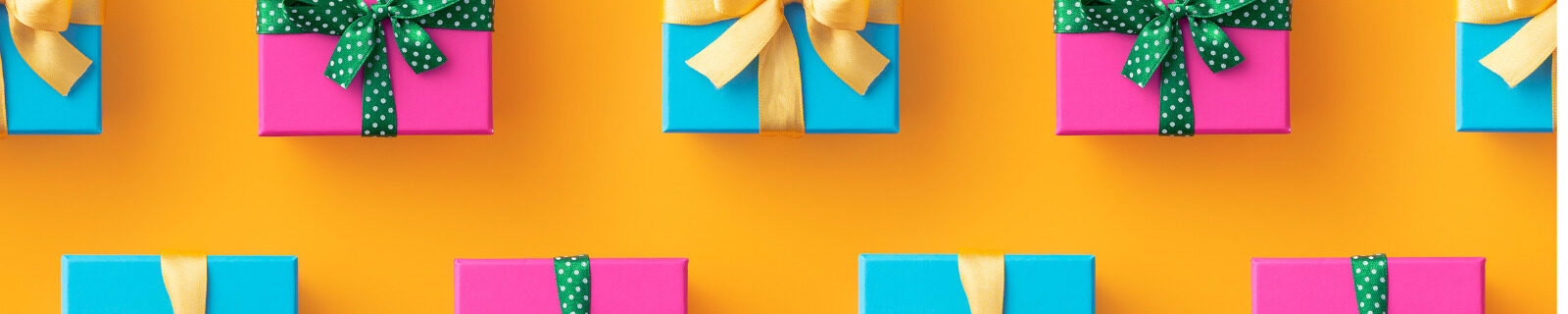 Orange background with brightly colored wrapped gifts in blue and pink