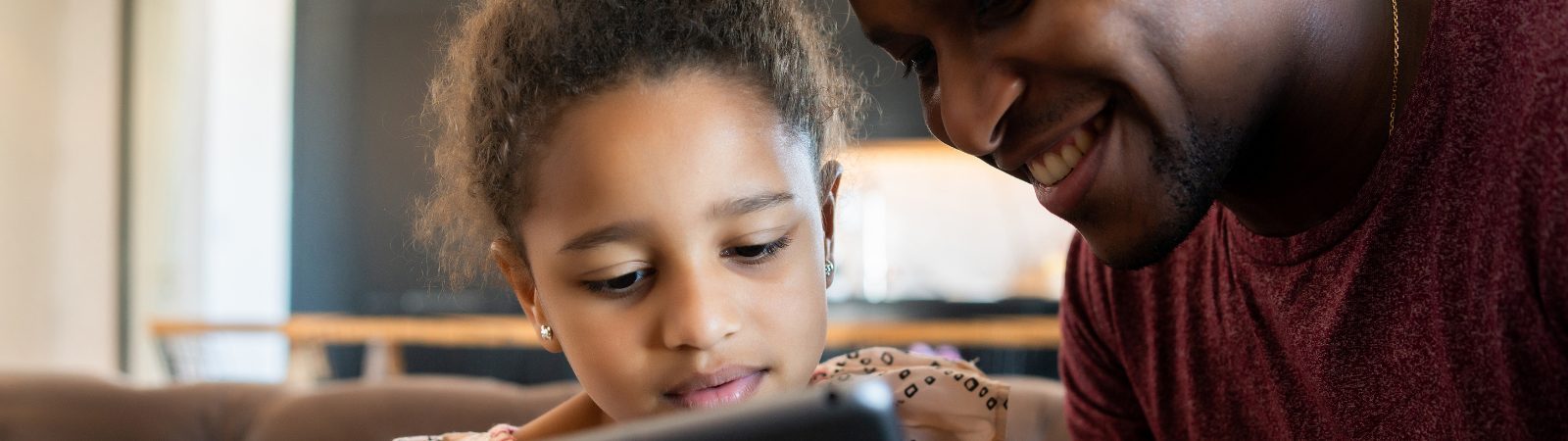 Parent looking at iPad with child