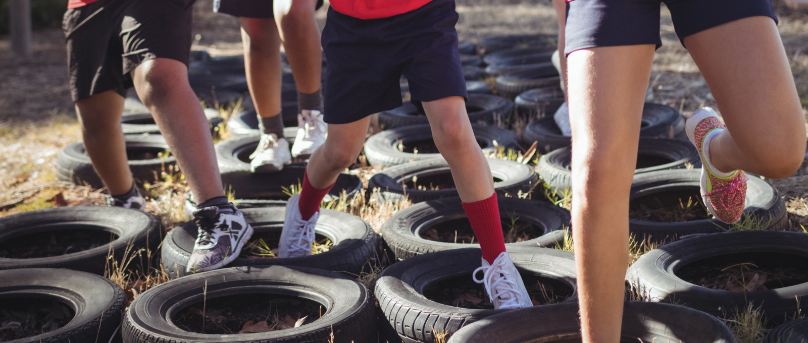 Children running through obstacles on ground. 