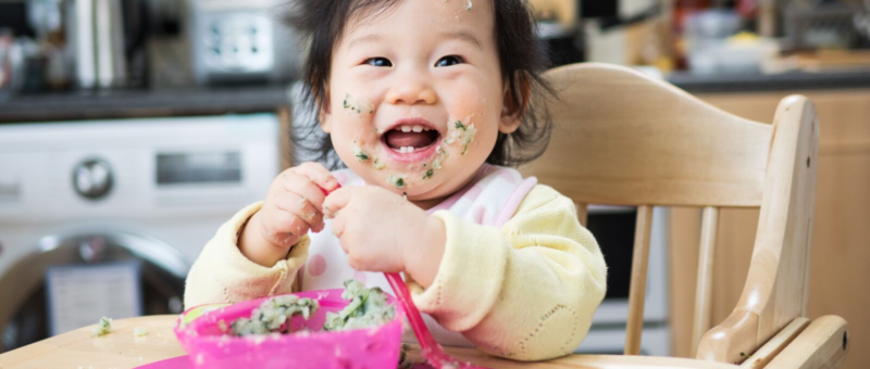 Baby learning how to eat solid foods