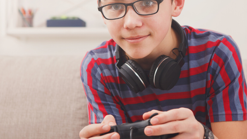 Child playing video games on the couch