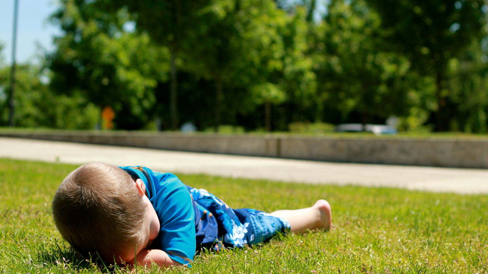 A child's behavior causing him to collapse on the grass.