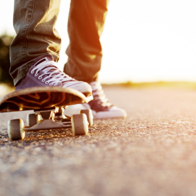 Feet of teenager standing on skateboard
