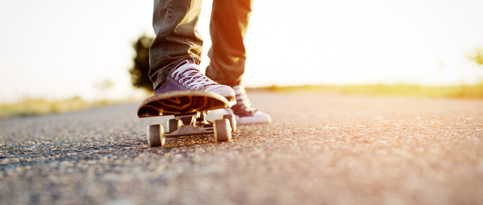 Feet of teenager standing on skateboard