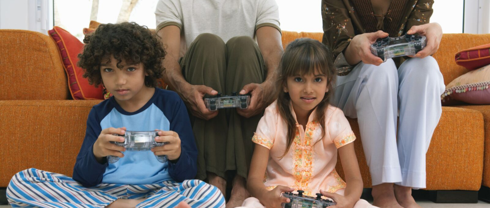 Kids enjoying screen time with their parents