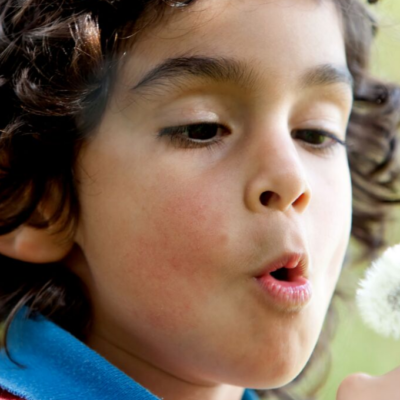 Exploring nature with a child blowing a dandelion