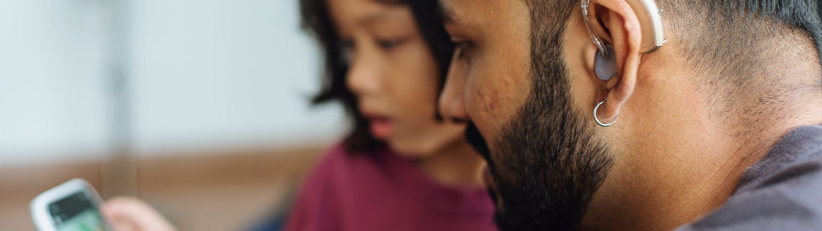 Parent and teen looking at phone together