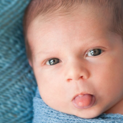 Baby sticking tongue out in response to the same from a grown up, example of mirror neurons