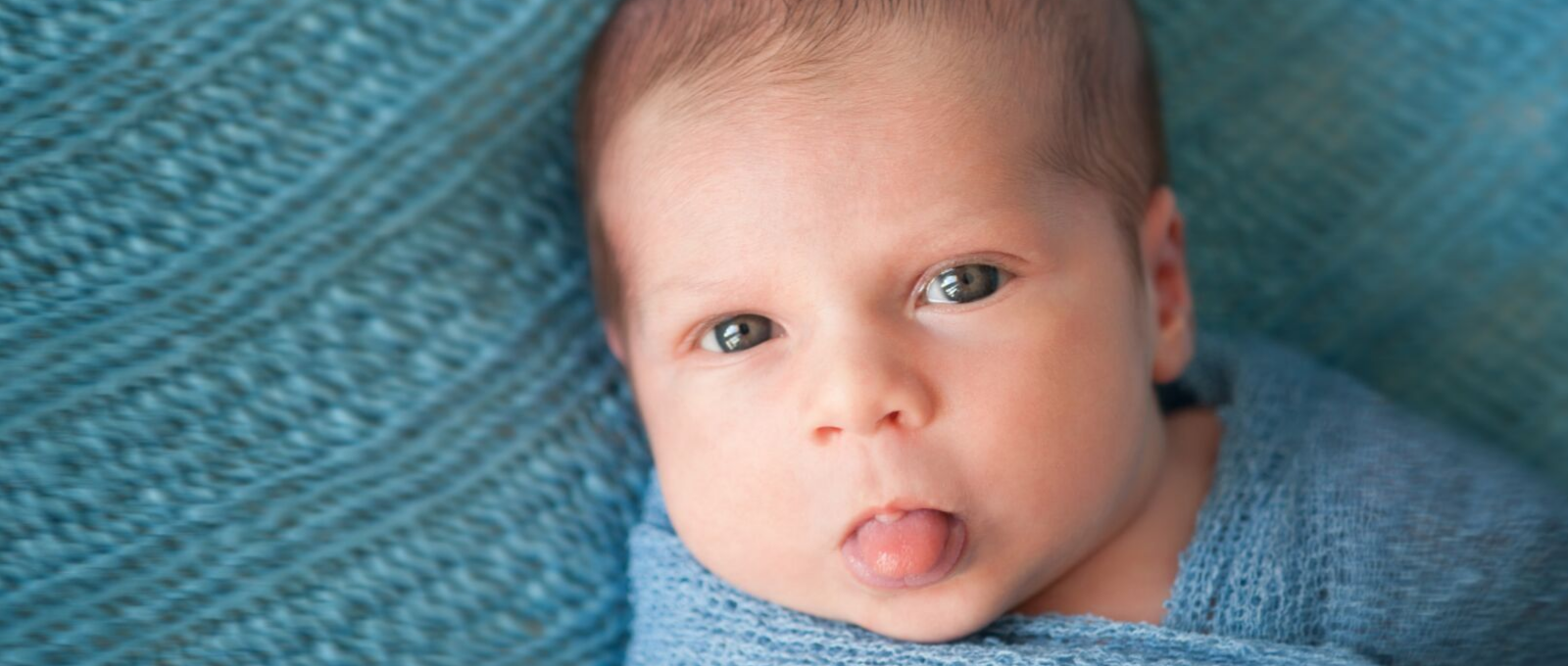 Baby sticking tongue out in response to the same from a grown up, example of mirror neurons