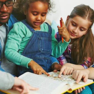 Dad engaging kids in book boosting early childhood literacy