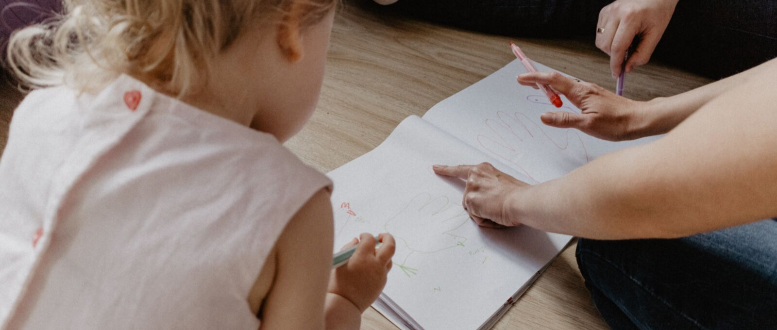 Parenting raising writer by playing and drawing with them on floor