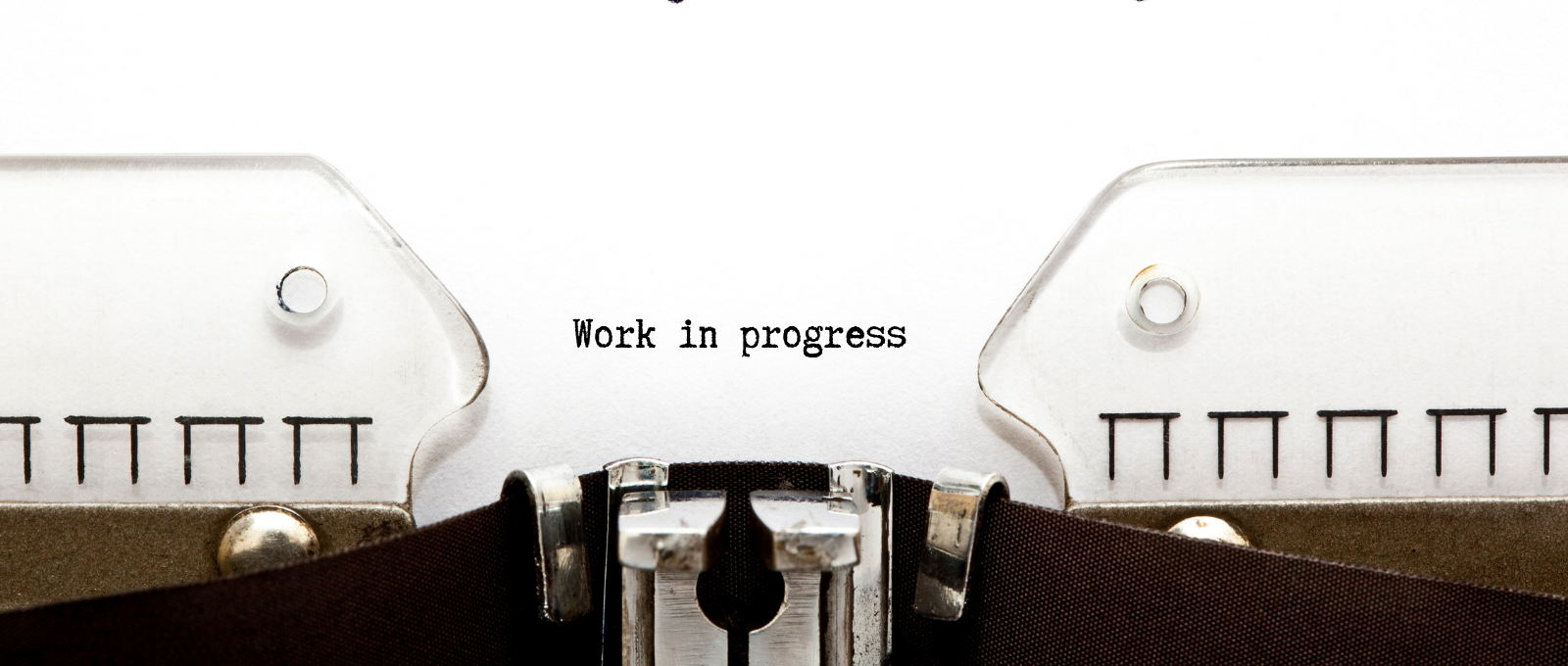 page coming out of typewriter that says Work In Progress